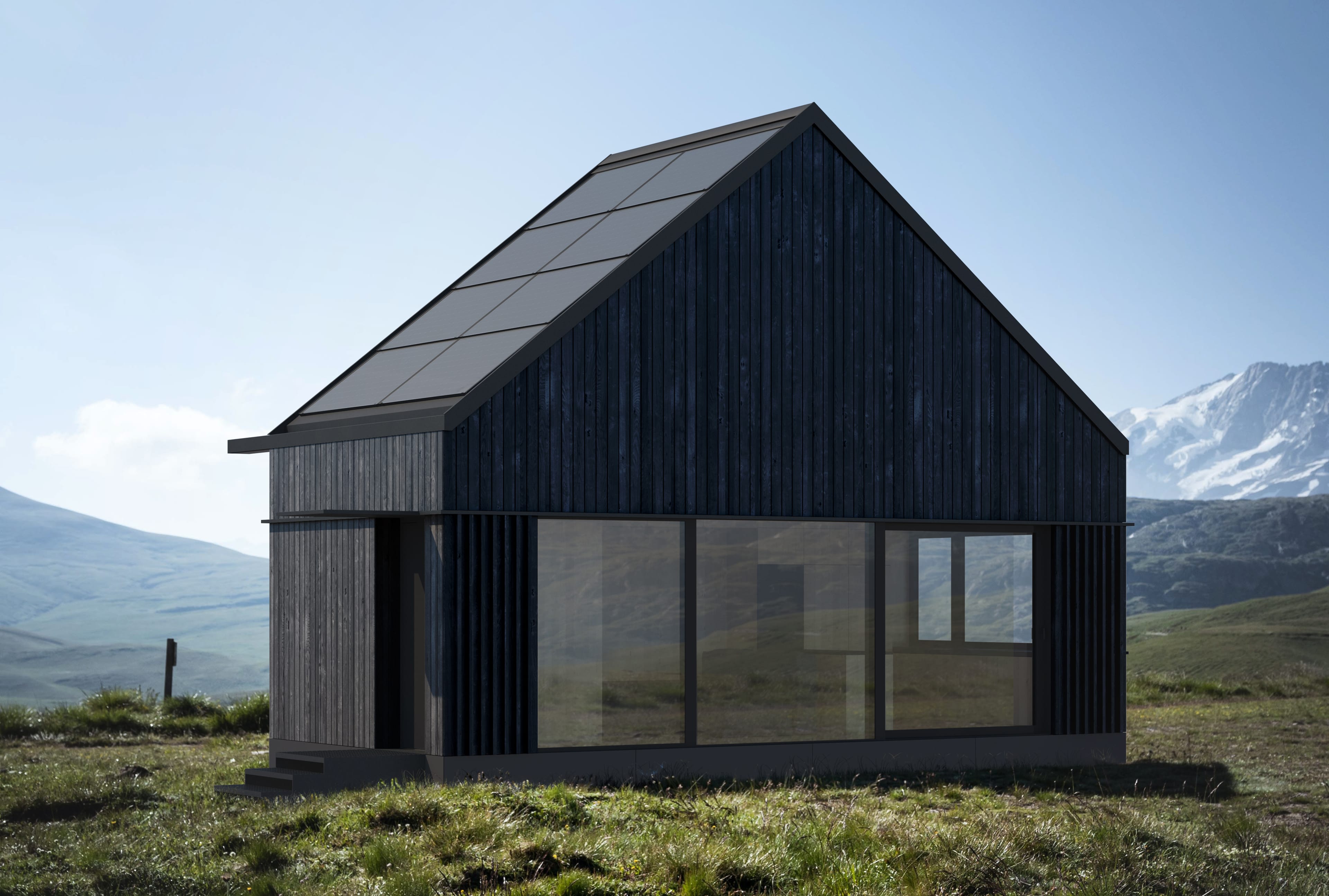 A dark, minimalist house with solar panels on the roof stands on a green hill. In the background, you can see snow-capped mountain peaks.