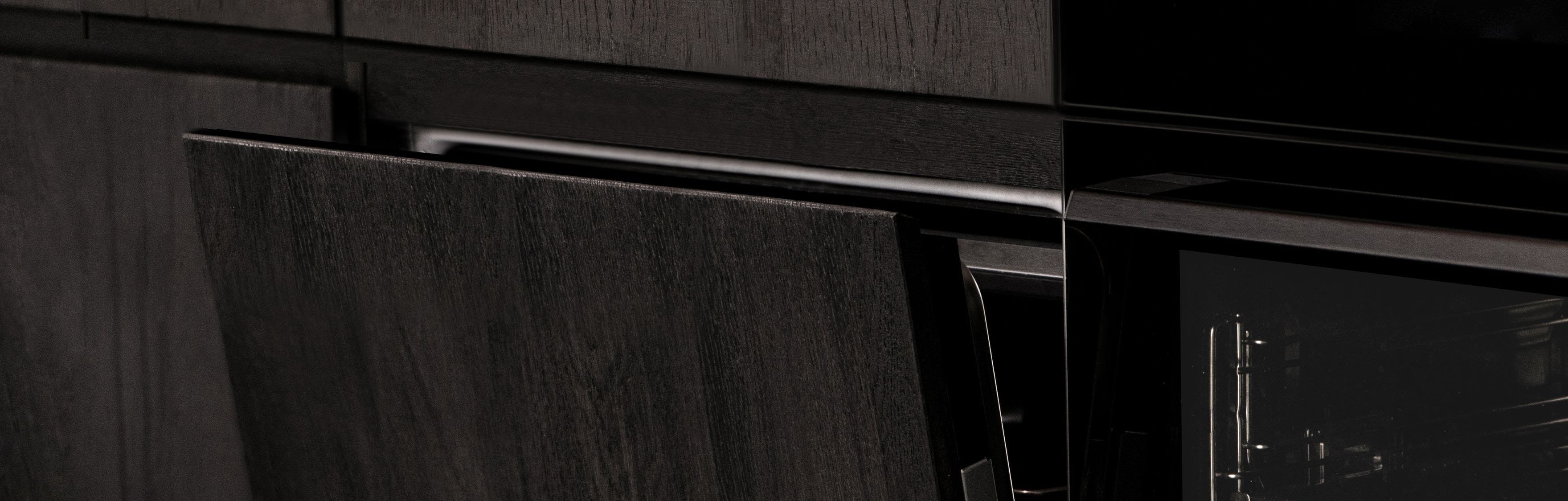Dark kitchen cabinetry with devices integrated into the home system.
