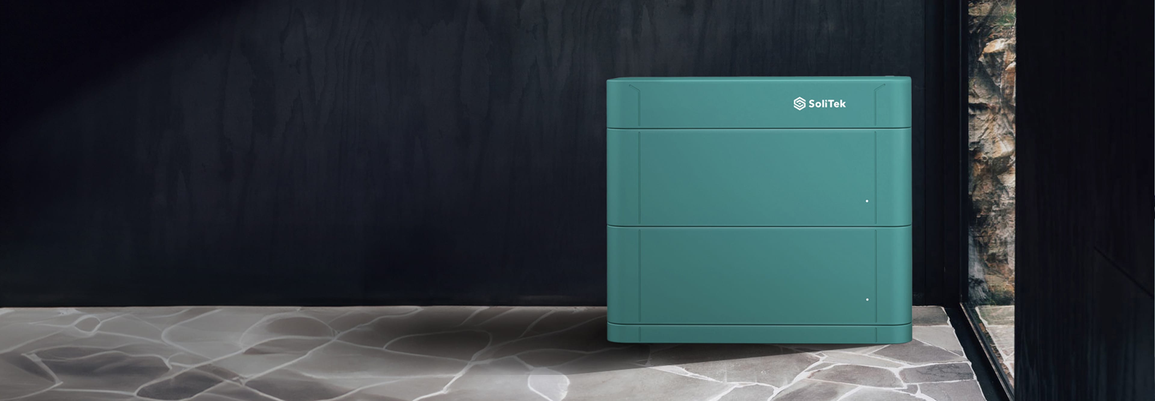 A close-up of a pitched roof covered with dark, integrated photovoltaic panels that form a smooth, uniform surface.