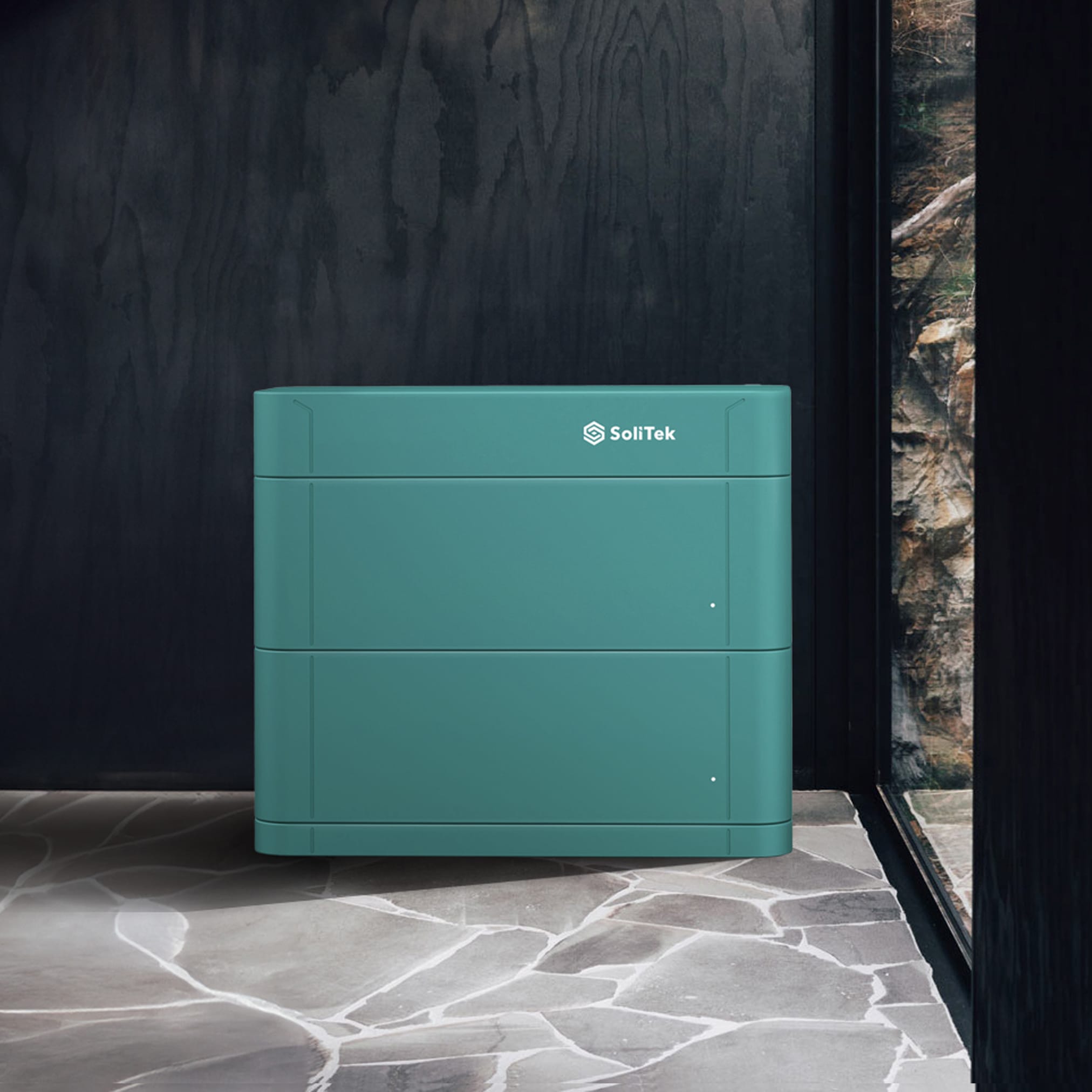 A close-up of a pitched roof covered with dark, integrated photovoltaic panels that form a smooth, uniform surface.