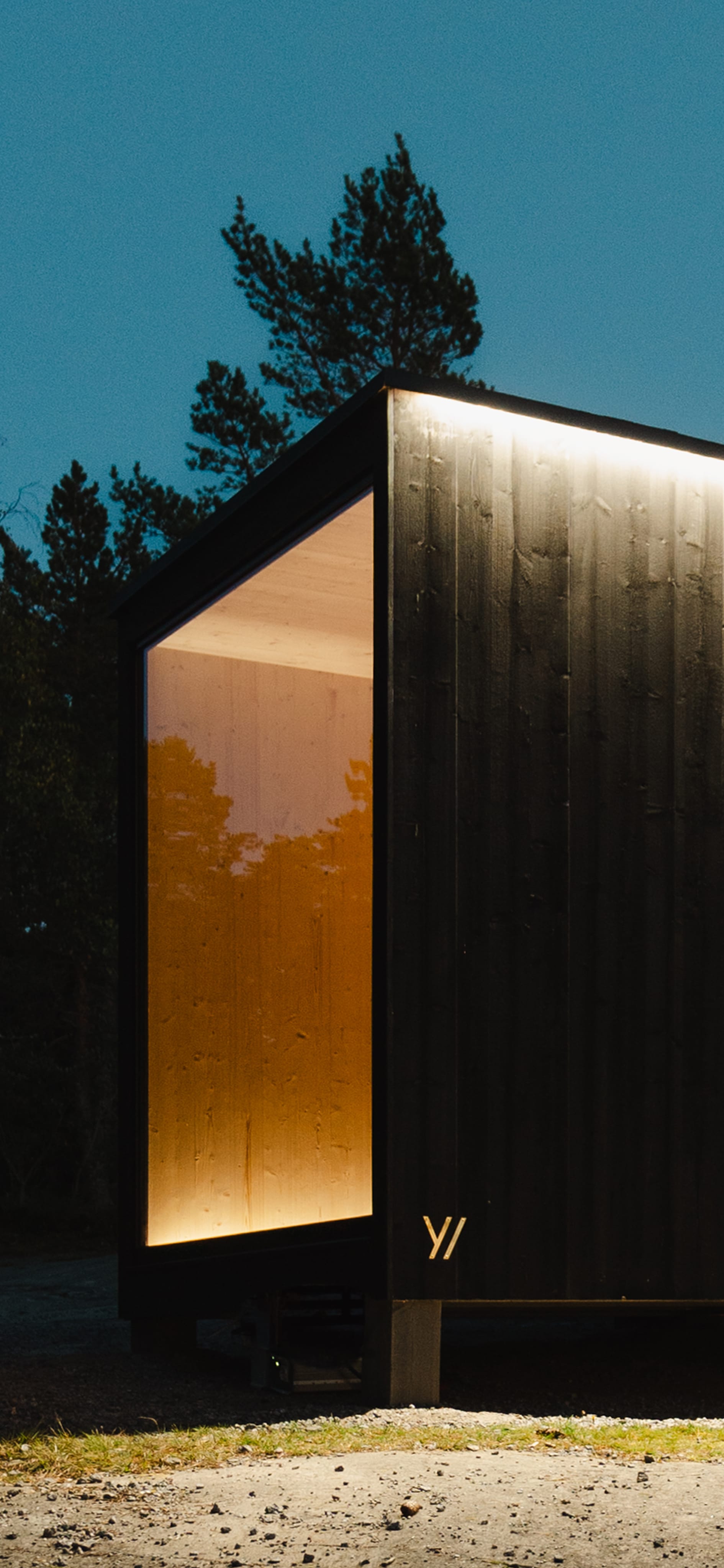 A modern hotel with a wooden facade in the mountains
