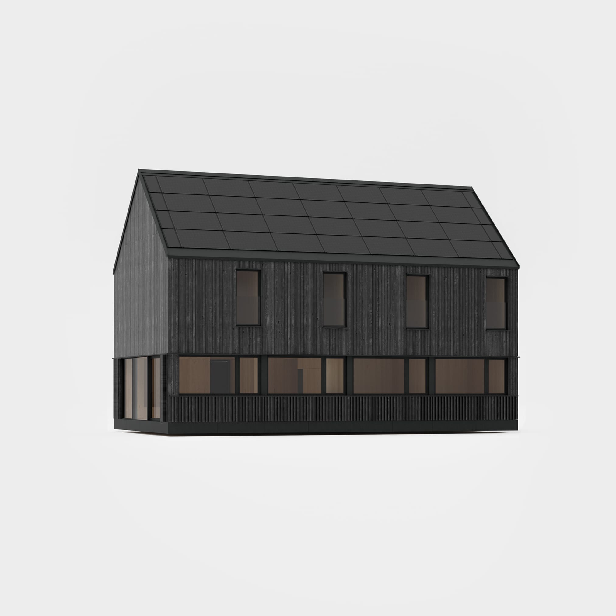 A dark, modern house with a roof entirely covered with photovoltaic panels, standing on a meadow at the foot of forested mountains.