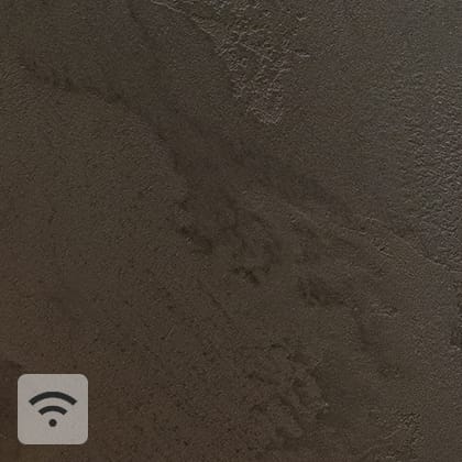 Close-ups of a textured, beige wall, with a white, oblong sensor mounted in the corner in the central part.