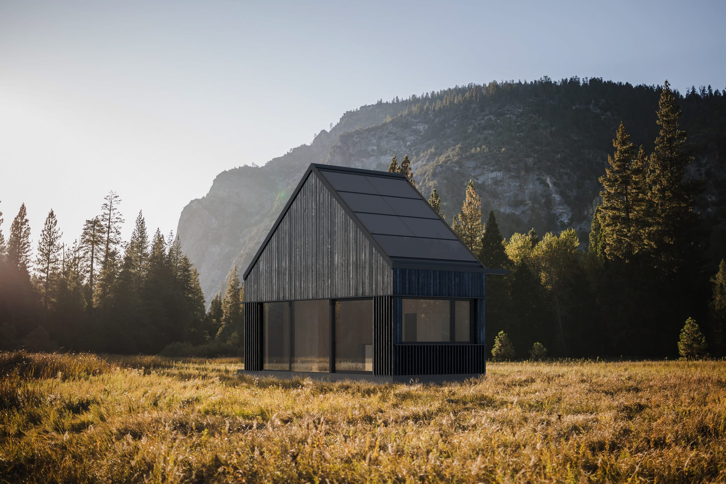 A Hombee home standing on an open plot with mountains and forest in the background.