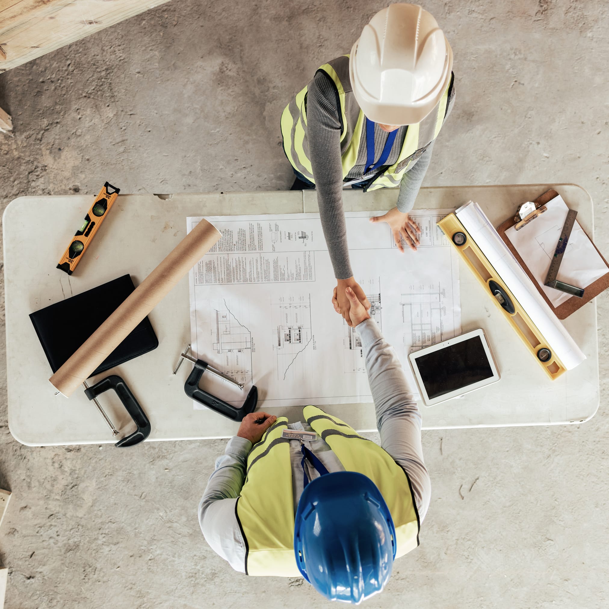 A person writing on a transparent board.